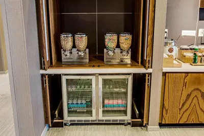 a cabinet with four glass vases in it at SpringHill Suites by Marriott Dayton Vandalia in Murlin Heights