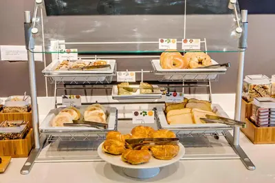 a display case with different types of bread and pastries at SpringHill Suites by Marriott Dayton Vandalia in Murlin Heights