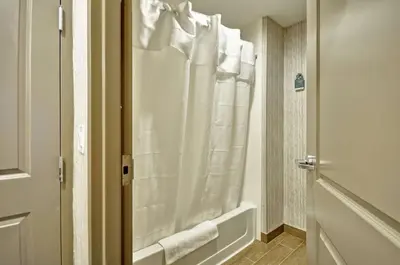 a bathroom with a shower with a white shower curtain at Homewood Suites by Hilton Cincinnati/West Chester in West Chester