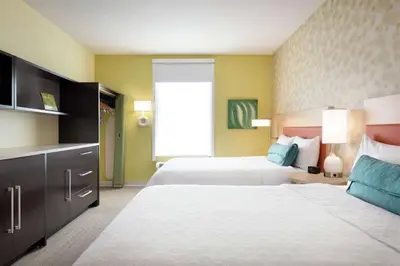 a hotel room with two beds and a large window at Home2 Suites by Hilton Cleveland Independence in Independence