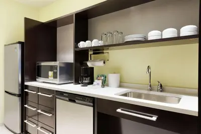 a kitchen with a sink and a microwave at Home2 Suites by Hilton Cleveland Independence in Independence