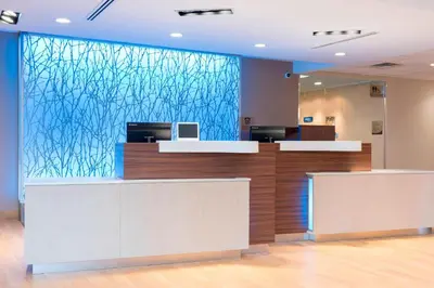 a lobby with a large glass wall in an office at Fairfield Inn & Suites by Marriott Medina in Medina