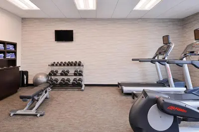a gym with cardio equipment in a room at Courtyard by Marriott Toledo North in Toledo
