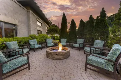 a group of chairs and a fire pit in a patio at Best Western Plus Franciscan Square Inn & Suites Steubenville in Steubenville