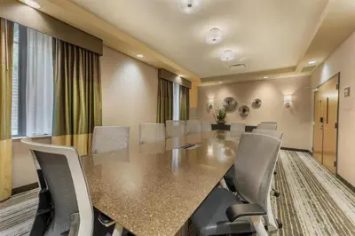 a conference room with a long table and chairs at Best Western Plus Franciscan Square Inn & Suites Steubenville in Steubenville