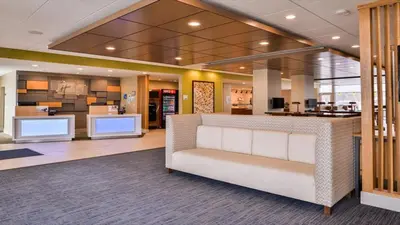 a lobby with a waiting area in a hospital at Holiday Inn Express & Suites - Parkersburg East by IHG in Parish-Morris Subdivision