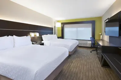 a hotel room with two beds and a flat screen tv at Holiday Inn Express & Suites - Parkersburg East by IHG in Parish-Morris Subdivision