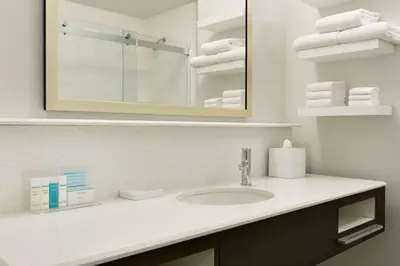 a bathroom with a sink and a mirror and towels at Hampton Inn By Hilton North Olmsted Cleveland Airport in North Olmsted