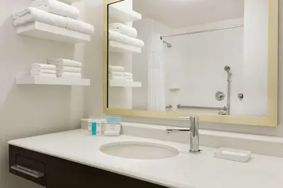 a bathroom with a sink and a mirror and towels at Hampton Inn By Hilton North Olmsted Cleveland Airport in North Olmsted