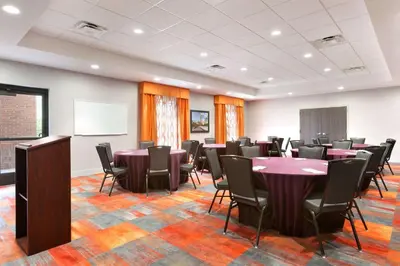 a conference room with tables and chairs and a whiteboard at Hampton Inn By Hilton North Olmsted Cleveland Airport in North Olmsted