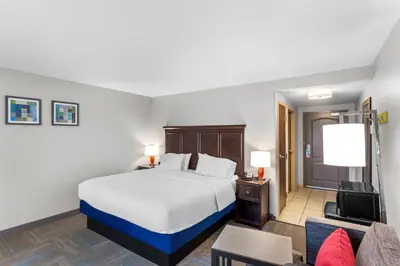 a hotel room with a bed and a couch at Hampton Inn University Area, Huntington, Wv in Huntington