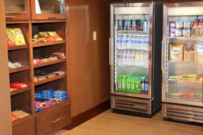 a room with two refrigerators with food and drinks at Fairfield Inn & Suites by Marriott Bowling Green in Bowling Green