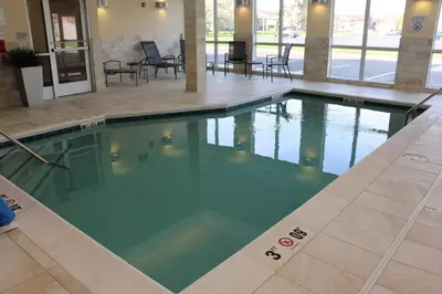 a swimming pool in the lobby of a hotel at Fairfield Inn & Suites by Marriott Bowling Green in Bowling Green