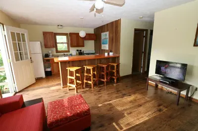 a living room with a couch and a table and a kitchen at Bird's Nest Resort in Put-in-Bay
