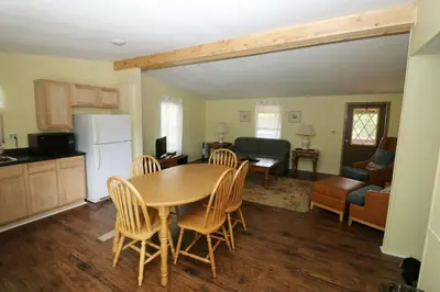 a kitchen and living room with a table and chairs at Bird's Nest Resort in Put-in-Bay