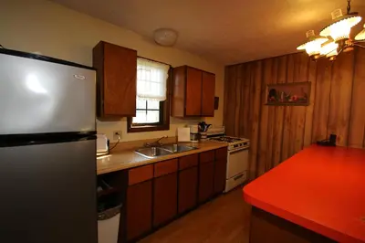 a kitchen with a refrigerator and a sink at Bird's Nest Resort in Put-in-Bay