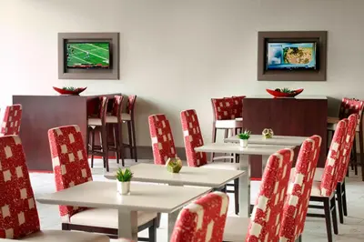 a dining room with tables and chairs and a television at Residence Inn by Marriott Columbus OSU in Columbus