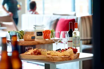 a table with a tray of cheese and wine at Residence Inn by Marriott Columbus OSU in Columbus