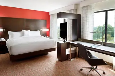 a hotel room with a bed and a desk and a computer at Residence Inn by Marriott Columbus OSU in Columbus