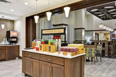 a lobby with a counter with boxes on it at Hampton Inn Suites Ashland, Ohio in Ashland