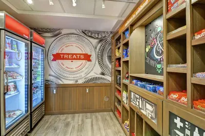 a grocery store aisle with a treats sign on the wall at Hampton Inn Suites Ashland, Ohio in Ashland