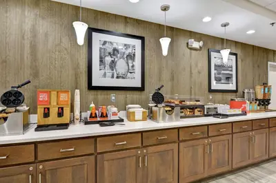 a kitchen with wooden cabinets and a counter top at Hampton Inn Suites Ashland, Ohio in Ashland