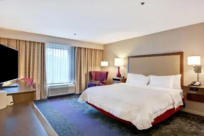a hotel room with a large bed and a desk at Hampton Inn Suites Ashland, Ohio in Ashland