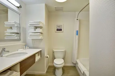a bathroom with a toilet and a sink and a tub at Hampton Inn Suites Ashland, Ohio in Ashland