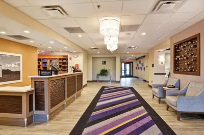 a lobby of a hospital with chairs and a rug at Hampton Inn Suites Ashland, Ohio in Ashland