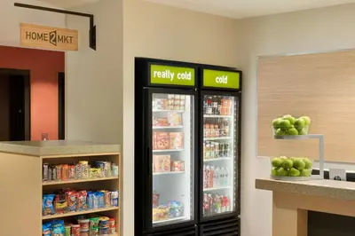 a refrigerator with food inside of a store at Home2 Suites By Hilton Middleburg Heights Cleveland in Middleburg Heights