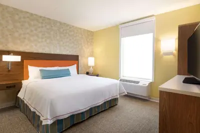 a hotel room with a large bed and a window at Home2 Suites By Hilton Middleburg Heights Cleveland in Middleburg Heights