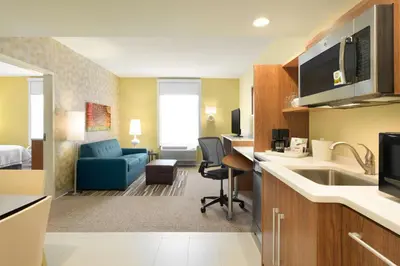 a hotel room with a kitchen and a living room at Home2 Suites By Hilton Middleburg Heights Cleveland in Middleburg Heights