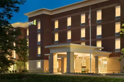 an office building with a flag in front of it at Home2 Suites By Hilton Middleburg Heights Cleveland in Middleburg Heights