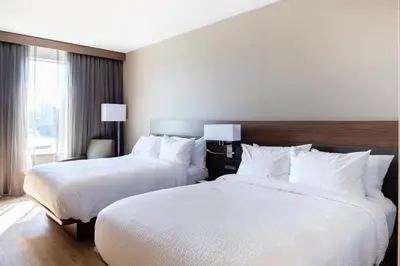 a hotel room with two beds and a window at AC Hotel by Marriott Cincinnati at The Banks in Cincinnati