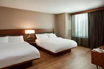 a hotel room with two beds and a window at AC Hotel by Marriott Cincinnati at The Banks in Cincinnati