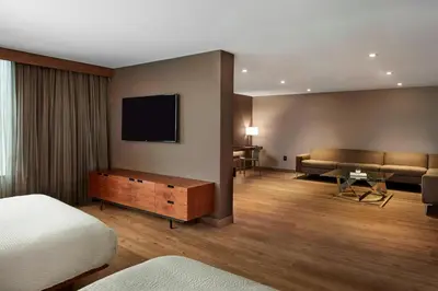 a hotel room with a bed and a flat screen tv at AC Hotel by Marriott Cincinnati at The Banks in Cincinnati