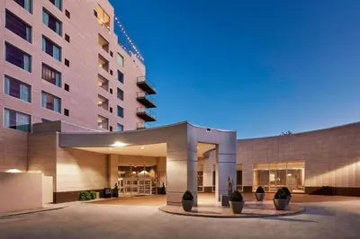 a large building with potted plants in front of it at AC Hotel by Marriott Cincinnati at The Banks in Cincinnati