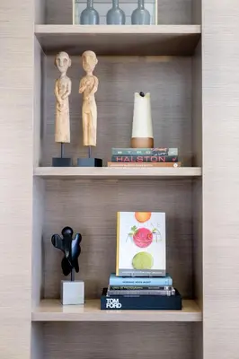 a book shelf with a lamp and some books at AC Hotel by Marriott Cincinnati at The Banks in Cincinnati