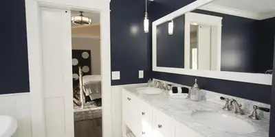 a bathroom with two sinks and a mirror at Anchor Inn Boutique Hotel in Put-in-Bay