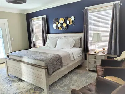 a bedroom with a bed and a blue wall at Anchor Inn Boutique Hotel in Put-in-Bay