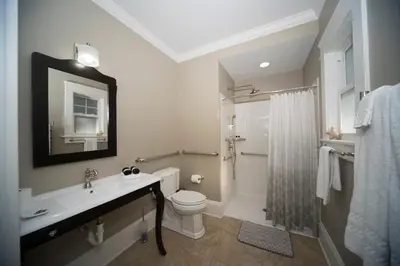 a bathroom with a sink and a toilet and a shower at Anchor Inn Boutique Hotel in Put-in-Bay