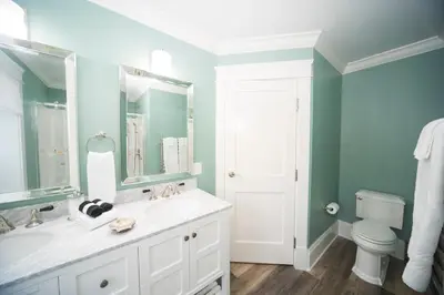 a bathroom with a white sink and a toilet at Anchor Inn Boutique Hotel in Put-in-Bay