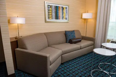 a living room with a couch in a hotel room at Fairfield Inn & Suites by Marriott Anderson in Anderson