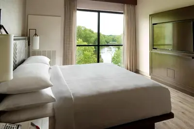 a large white bed in a room with a window at Marriott Columbus OSU in Columbus