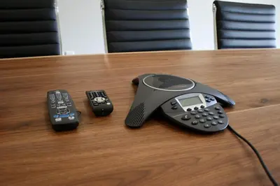 two remote controls and a phone on a table at Sleep Inn & Suites Galion in Galion