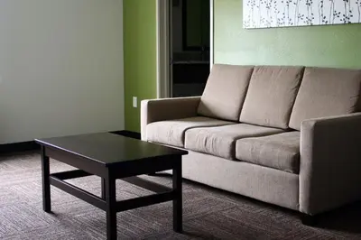 a living room with a couch and a coffee table at Sleep Inn & Suites Galion in Galion
