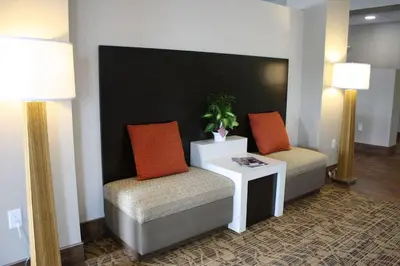 a room with two chairs and a table and two lamps at Sleep Inn & Suites Galion in Galion
