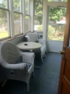 a room with chairs and a table and windows at Aunt Jane's Two in Put-in-Bay
