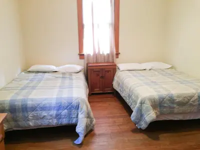 two beds sitting in a room with a window at Aunt Jane's Two in Put-in-Bay