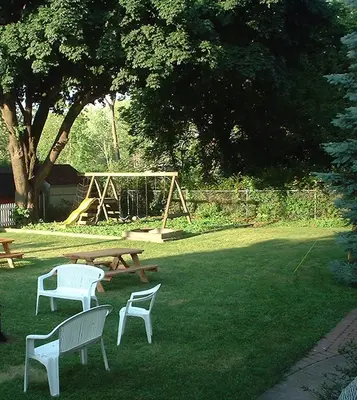 a park with benches and a picnic table and a playground at Aunt Jane's Victorian Manor in Put-in-Bay
